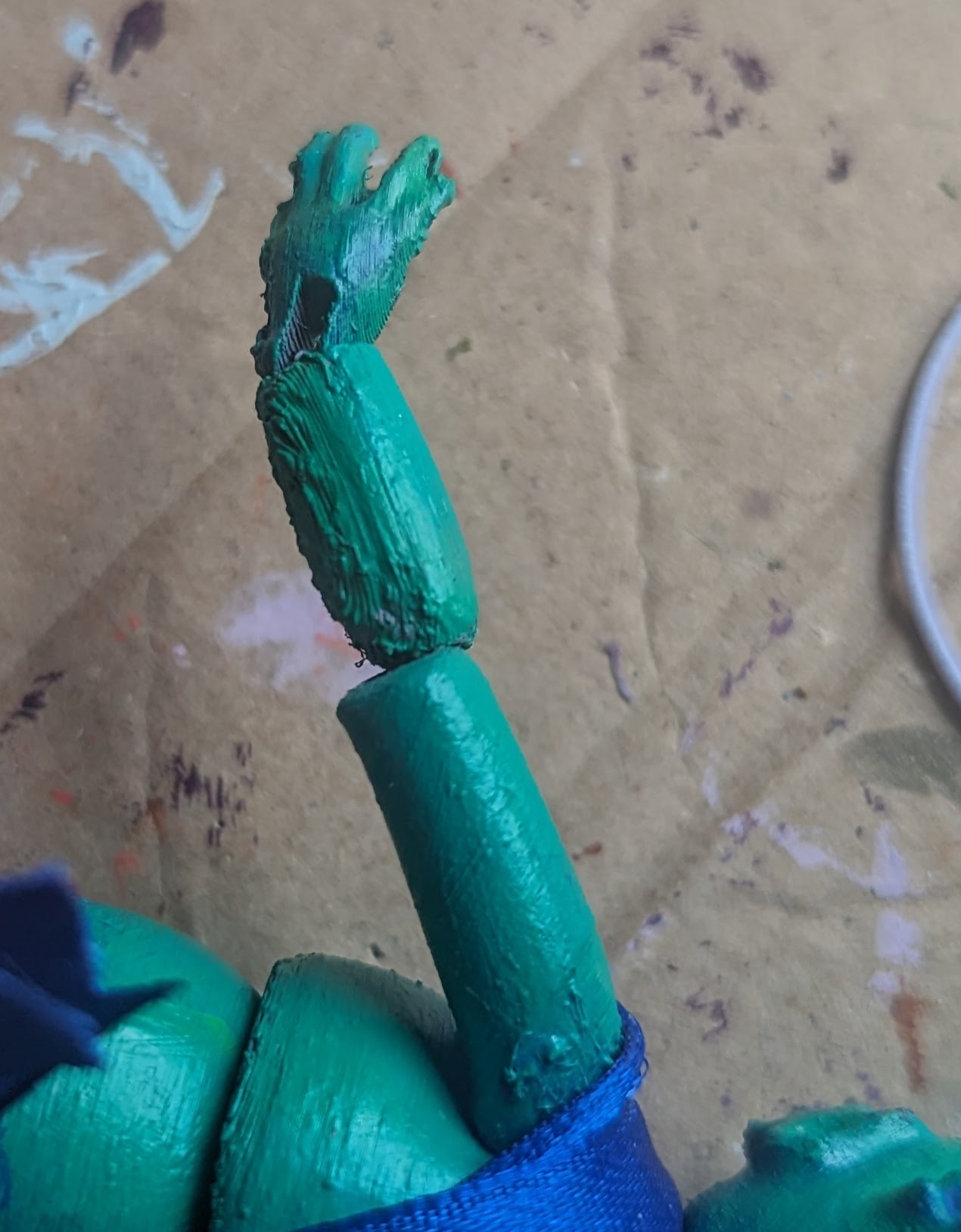 A close-up of the seafoam green mermaid's arm, specifically the elbow joint. The end of the upper arm has an error where it does not form a socket for an elbow.