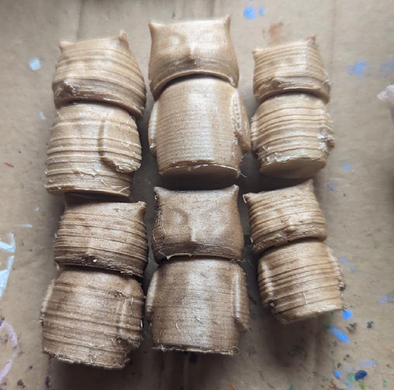 Two rows of the three sets of owls, lying on their backs. The furthest left set have rings of texture, like wood grain, the same as the small ones on the right. They also have more imperfections than the smooth ones in the middle.